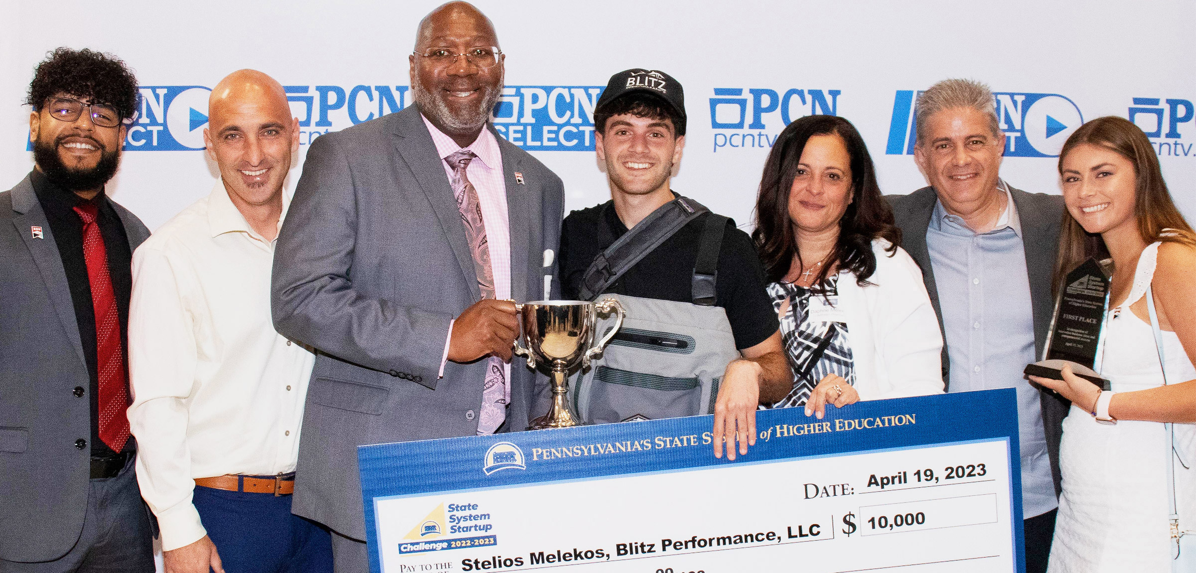 Stelios Melikos, 2023 State System Startup Challenge winner, with family and friends and ESU President, Kenneth Long