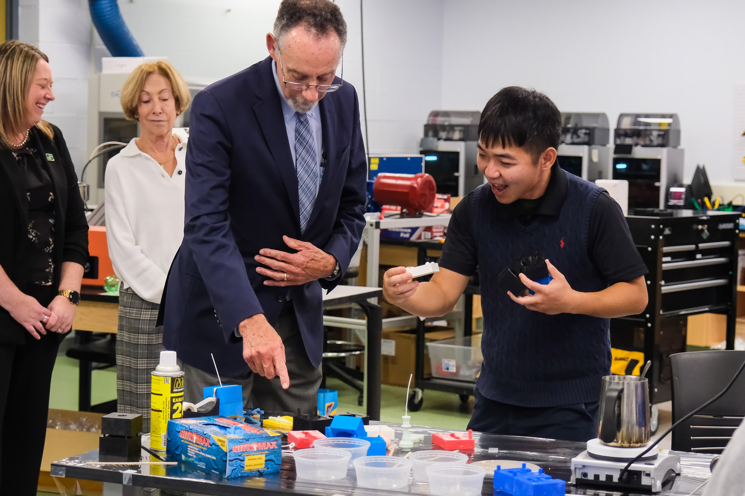 A Slippery Rock University student shows Chancellor Fiorentino around the Mechanical Engineering lab.