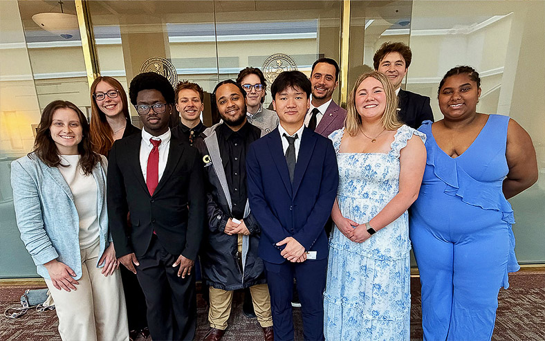 Commonwealth University Student Government Board members pose outside a legislator’s office at the state Capitol.