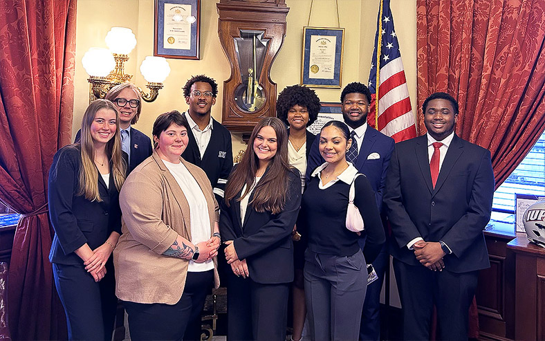 Indiana University of Pennsylvania Student Government Association members pose in a legislator’s office at the State Capitol.