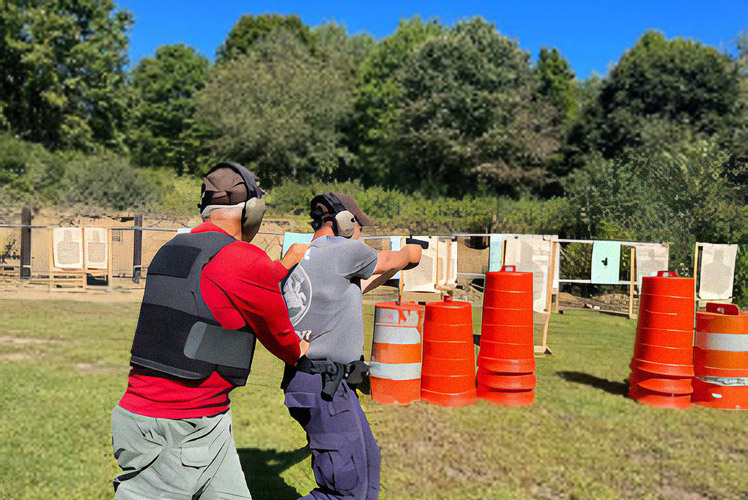 An instructor works with a cadet at the IUP Police Academy on proper weapon handling techniques.