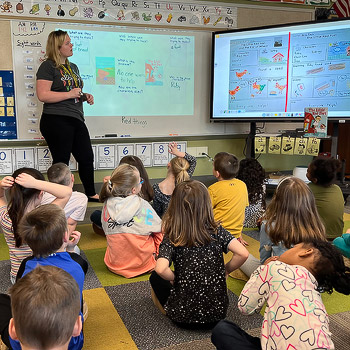 Allison Ross teaching a lesson to elementary school students.