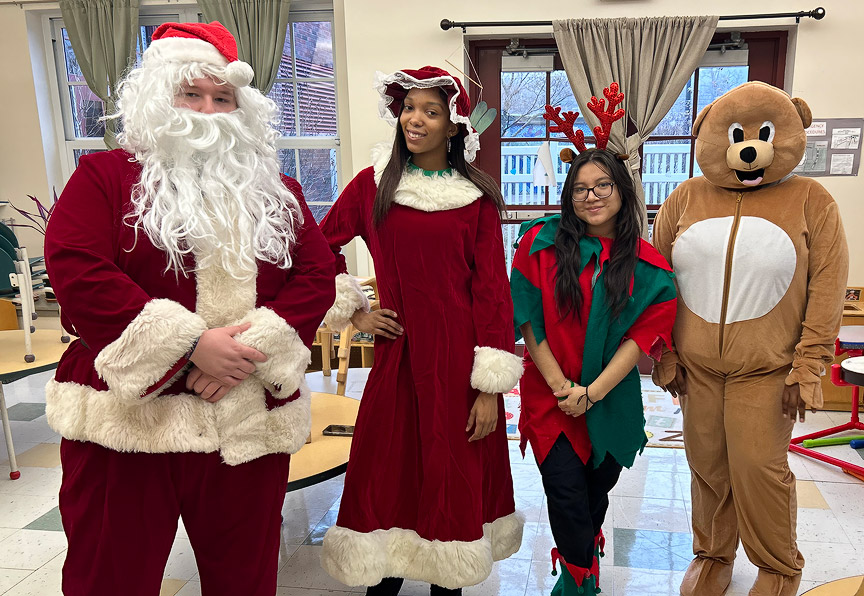 Santa and Mrs. Claus talking to children at the Teddy Bear Drive