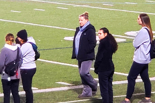 Mackenzie Vajda watches from the sidelines at a football game at Indiana University of Pennsylvania.